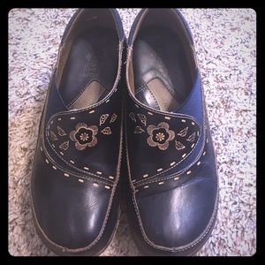 Size 8 leather clogs with tooling.